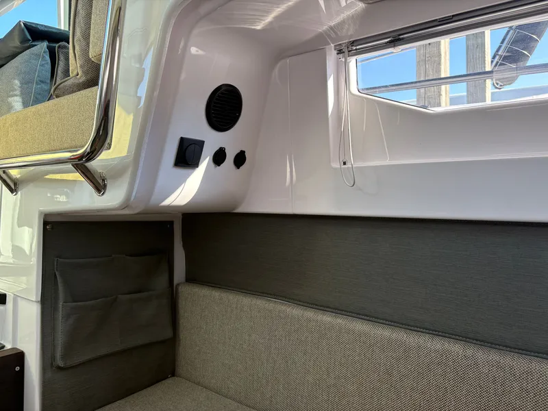 Slide: The Image of Interior of the 2024 Axopar 37 XC Cross Cabin with gray upholstery and a window. - 17