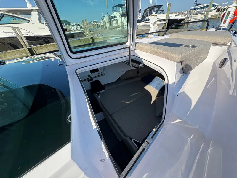 Slide: The Image of The image shows the open cabin roof of a 2024 Axopar 37 XC Cross Cabin at a marina. - 43