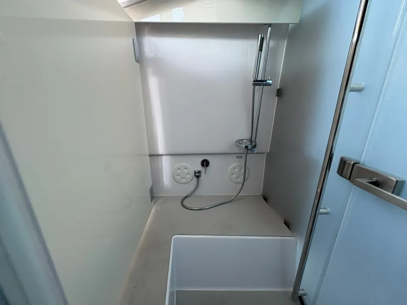 Slide: The Image of The shower in the 2024 Axopar 37 XC Cross Cabin is modern and functional. - 29