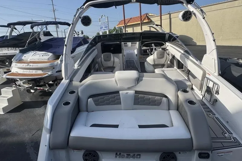 Slide: The Image of 2019 Four Winns HD240 Surf boat with spacious seating and modern design. - 6