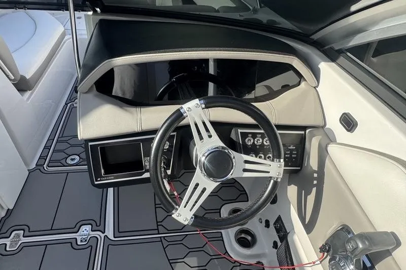 Slide: The Image of 2019 Four Winns HD240 Surf boat dashboard with steering wheel and controls. - 3