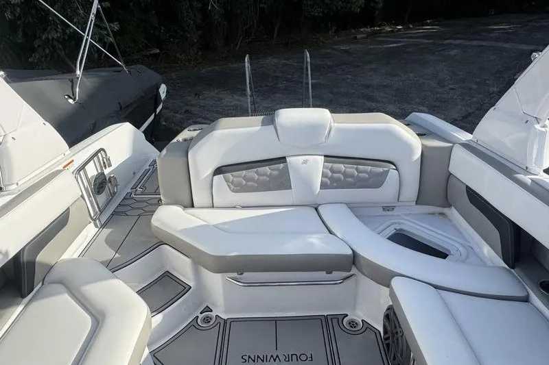 Slide: The Image of 2019 Four Winns HD240 Surf boat interior with cushioned seating and sleek design. - 8