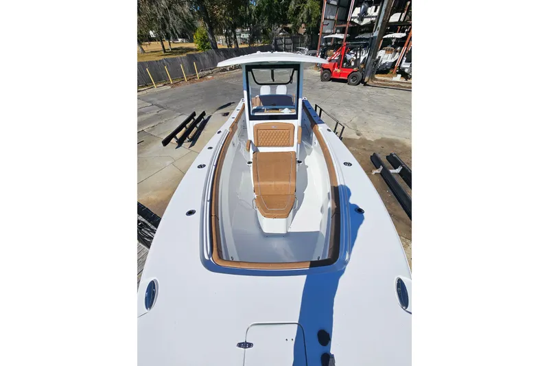 Slide: The Image of 2026 Sea Hunt Ultra 275 Coffin Box boat, docked, showcasing spacious deck and seating. - 29