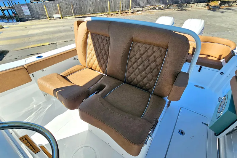 Slide: The Image of Luxurious seating on 2026 Sea Hunt Ultra 275 Coffin Box boat, featuring brown upholstery. - 18