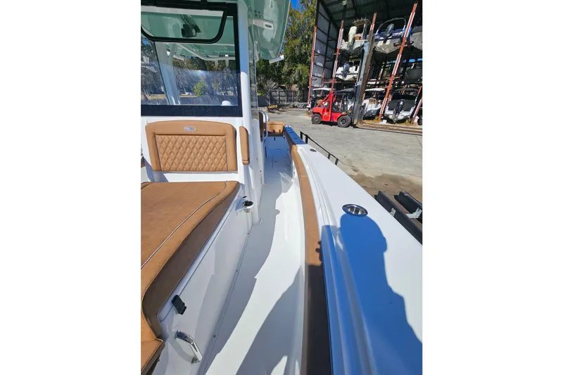 Slide: The Image of 2026 Sea Hunt Ultra 275 Coffin Box boat interior with tan seating and storage area. - 27