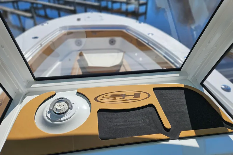 Slide: The Image of 2026 Sea Hunt Ultra 275 Coffin Box dashboard with compass and logo detail. - 14