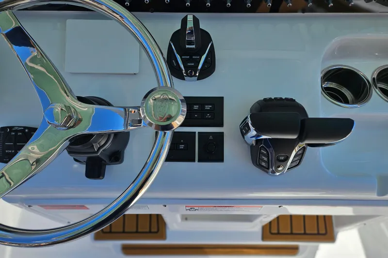 Slide: The Image of Steering console of 2026 Sea Hunt Ultra 275 Coffin Box boat, featuring modern controls. - 16