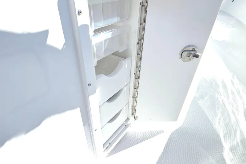 Slide: The Image of Storage compartment on 2026 Sea Hunt Ultra 275 Coffin Box boat, featuring secure latch. - 22