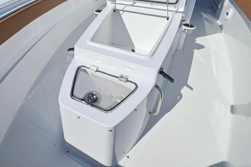 Slide: The Image of 2026 Sea Hunt Ultra 275 Coffin Box, open storage compartment on a sleek boat deck. - 26