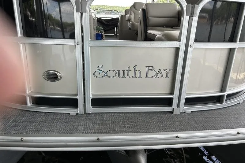 Slide: The Image of 2015 South Bay 524 SLTT pontoon boat with beige seating and silver railing. - 4