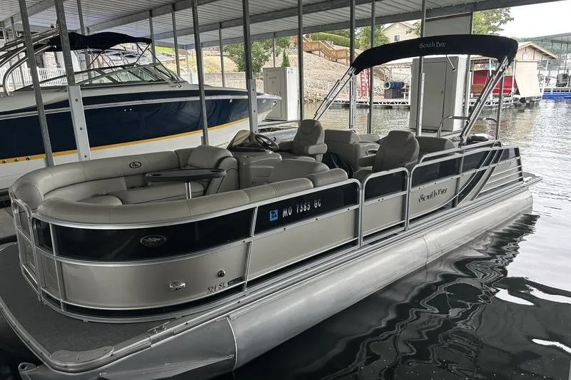 Slide: The Image of 2015 South Bay 524 SLTT pontoon boat docked in a marina. - 1