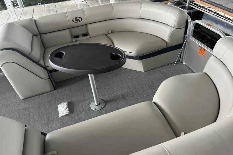 Slide: The Image of Luxurious seating area on a 2015 South Bay 524 SLTT pontoon boat with a central table. - 17