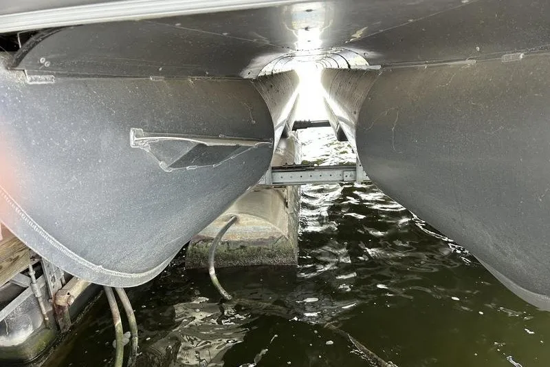 Slide: The Image of Underneath view of a 2015 South Bay 524 SLTT pontoon boat on water. - 16