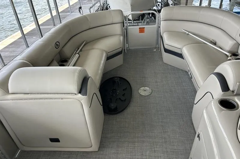 Slide: The Image of 2015 South Bay 524 SLTT pontoon boat interior with beige seating and carpeted floor. - 8