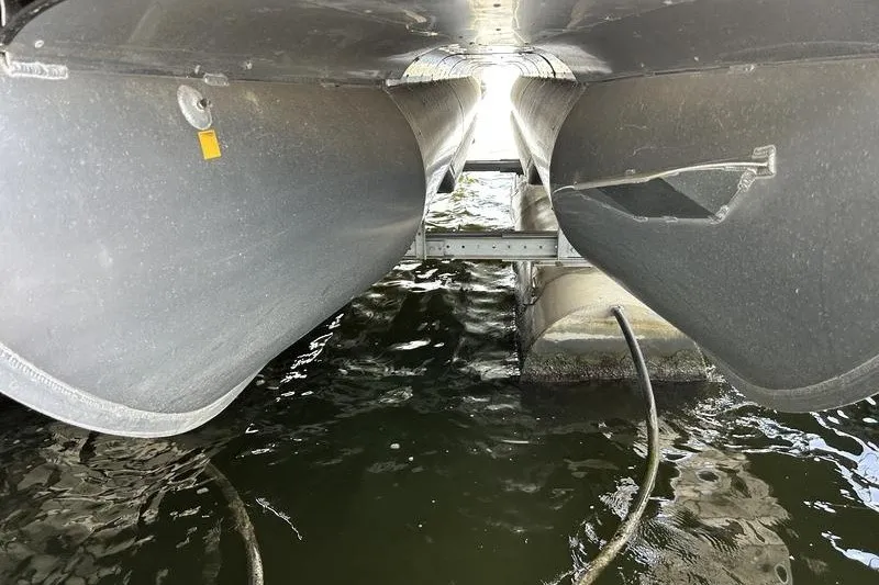 Slide: The Image of Underneath view of a 2015 South Bay 524 SLTT pontoon boat on water. - 15