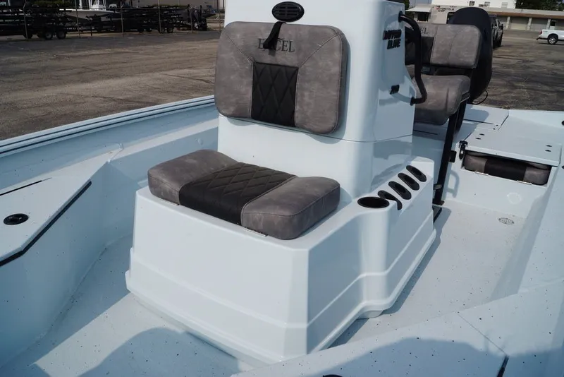 Slide: The Image of 2027 Excel 203 Bay Pro Elite boat interior with cushioned seating and console. - 15
