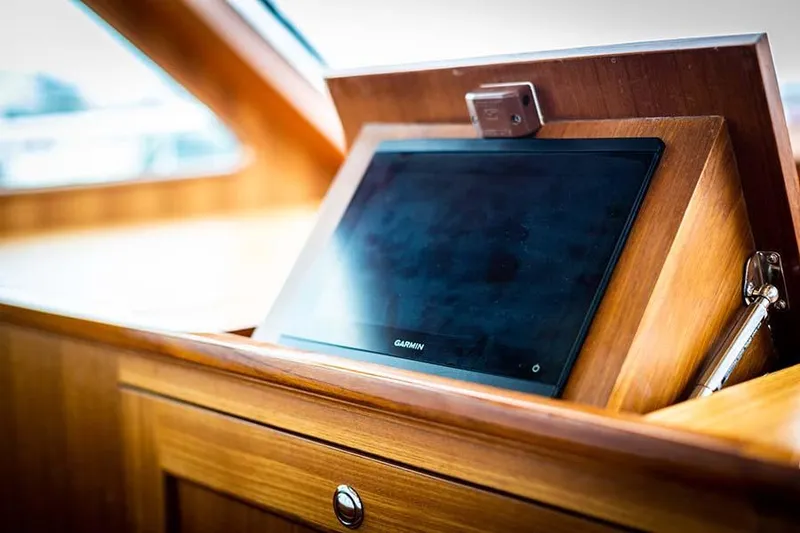 Slide: The Image of A modern navigation system is installed in a sleek wooden housing on the yacht. - 40