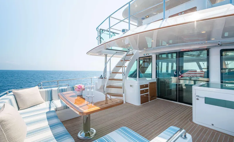 Slide: The Image of The 2020 Hunt Yachts Ocean 63 Flybridge features a sleek deck with seating area and ocean view. - 13
