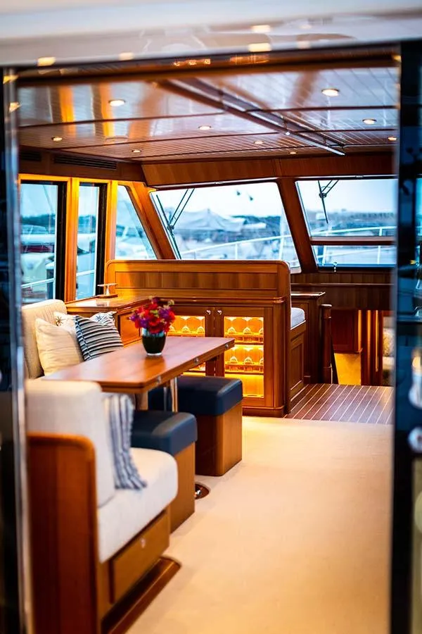 Slide: The Image of Interior of the 2020 Hunt Yachts Ocean 63 Flybridge with elegant wood finish and cozy seating area. - 26