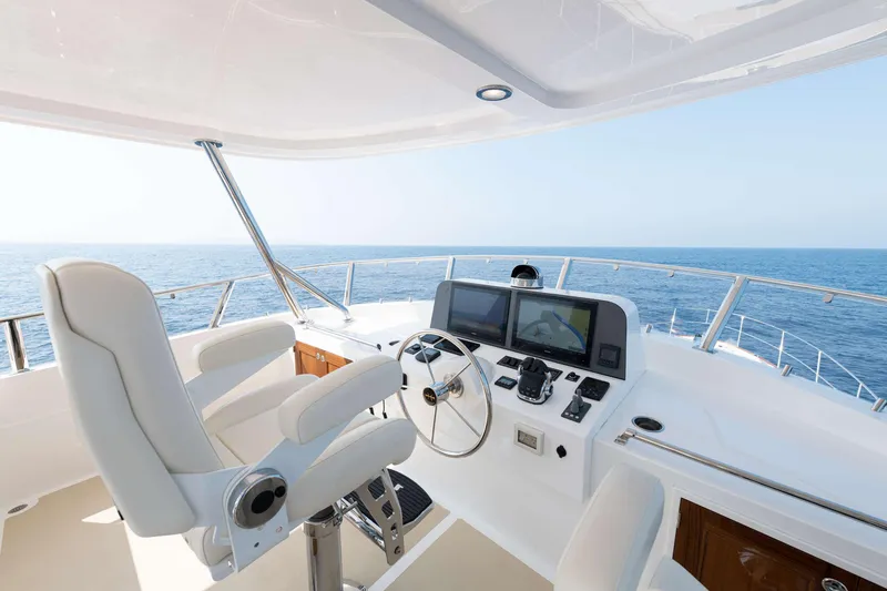 Slide: The Image of Flybridge of the 2020 Hunt Yachts Ocean 63 with helm station and ocean view. - 9