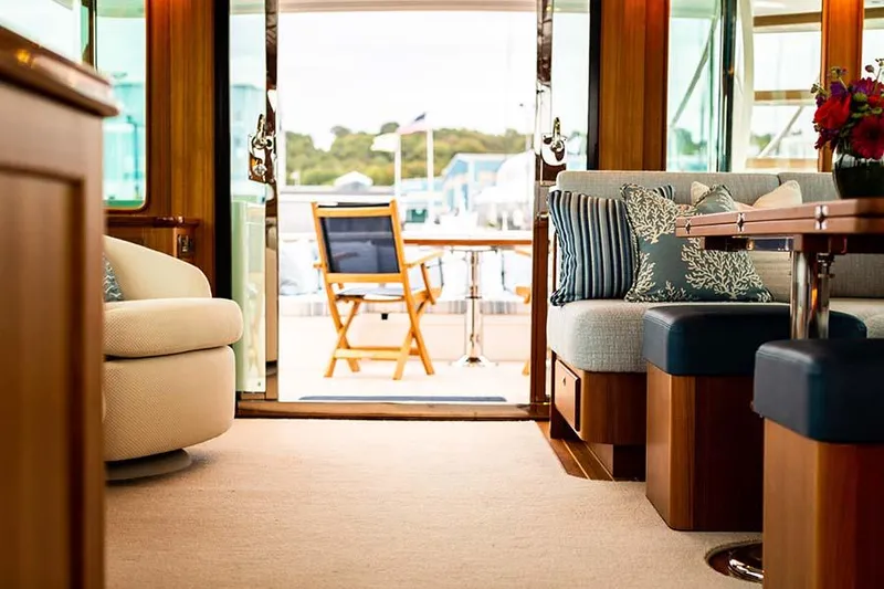 Slide: The Image of Interior view of a luxury yacht with comfortable seating and a view of the deck. - 28