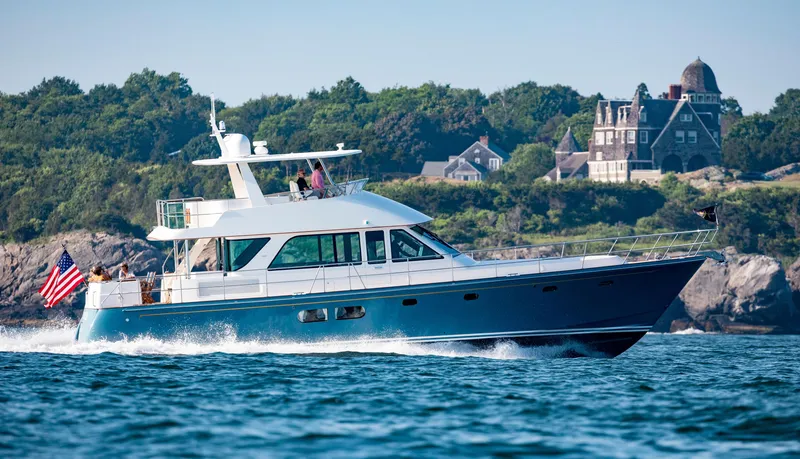 The Image of The 2020 Hunt Yachts Ocean 63 Flybridge cruising on the water with a coastal backdrop. - 0