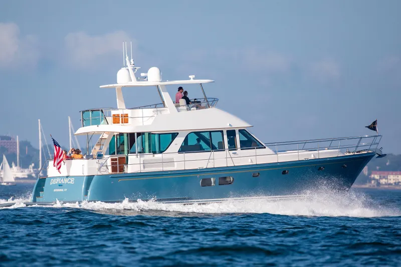 Slide: The Image of The 2020 Hunt Yachts Ocean 63 Flybridge cruising on the water, featuring a sleek blue hull design. - 4