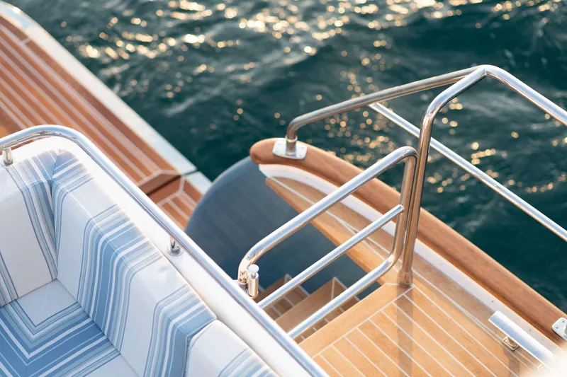 Slide: The Image of The 2020 Hunt Yachts Ocean 63 Flybridge features an elegant deck with striped upholstery. - 17