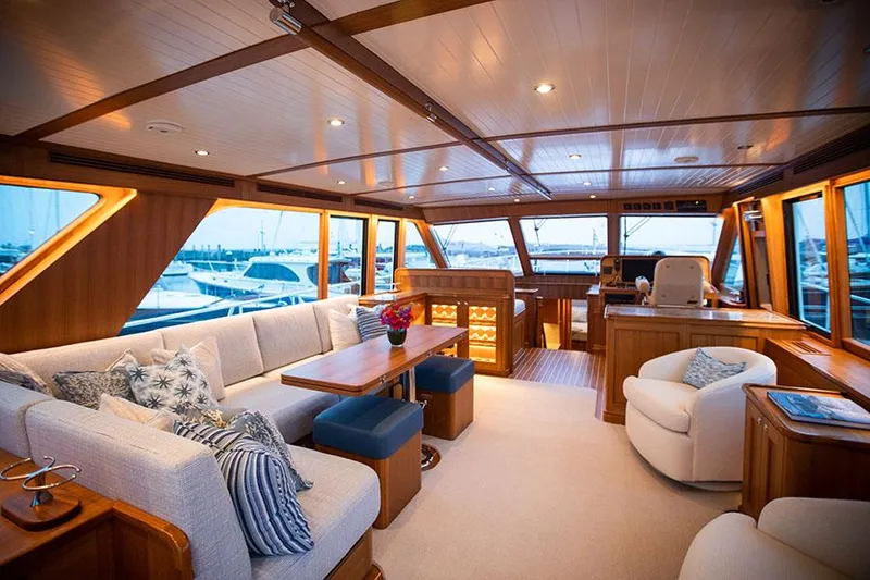 Slide: The Image of Luxurious yacht salon with comfortable sofas, wood paneling, and large windows overlooking the marina. - 27