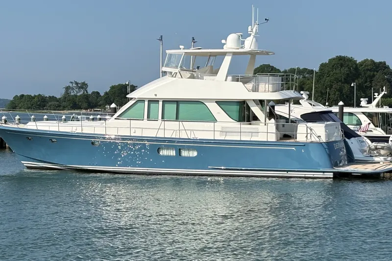 Slide: The Image of 2020 Hunt Yachts Ocean 63 Flybridge in marina, blue hull, sunny day. - 77