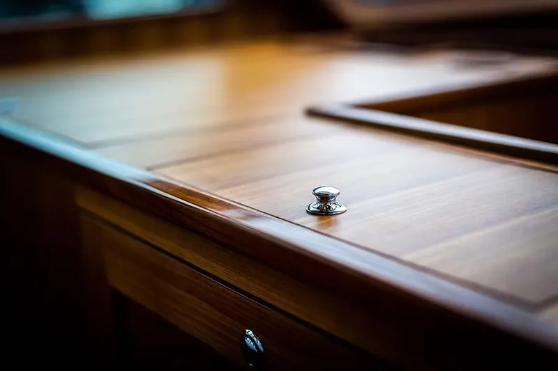 Slide: The Image of Close-up of an elegant wooden cabinet with a shiny knob on a yacht. - 41