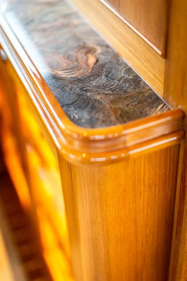 Slide: The Image of Close-up of an elegant wooden cabinet with a polished stone countertop. - 39