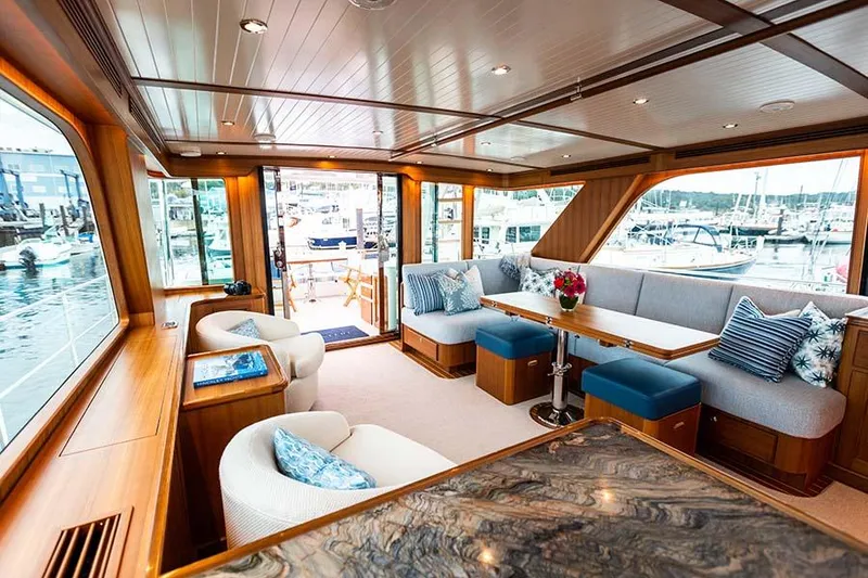 Slide: The Image of The interior of the 2020 Hunt Yachts Ocean 63 Flybridge features an elegant seating area with large windows. - 30