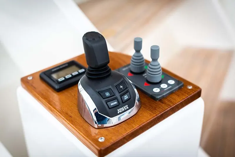 Slide: The Image of Control console with joystick and controls on a wooden panel. - 18