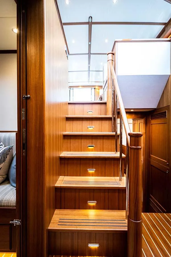 Slide: The Image of An elegant wooden staircase with built-in lighting leads to an upper deck. - 48
