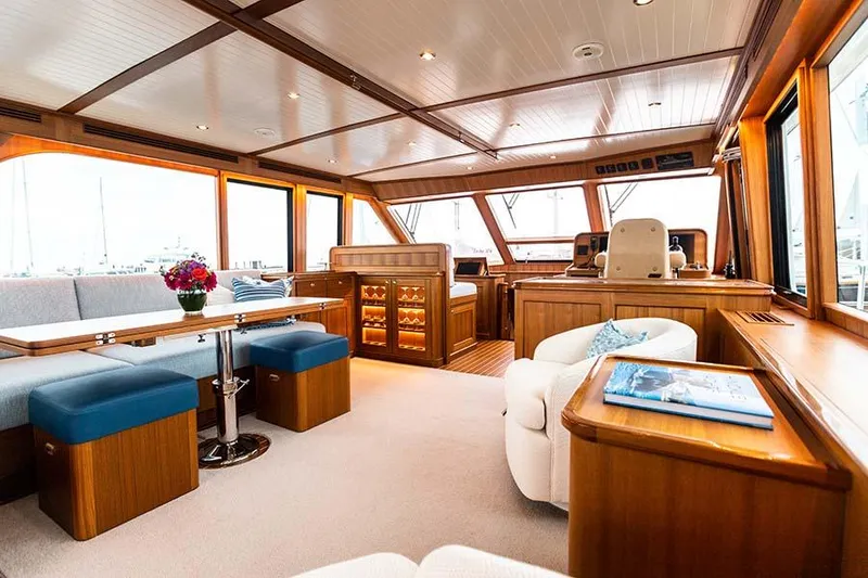 Slide: The Image of Interior of a luxury yacht with wood finishes, comfortable seating, and large windows. - 23