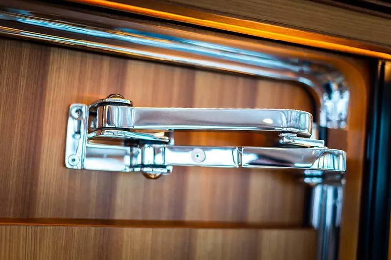 Slide: The Image of Close-up of a shiny metal handle on a wooden surface. - 32