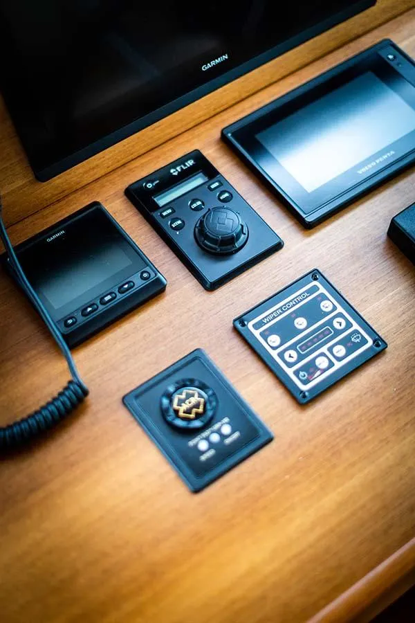 Slide: The Image of The image shows a yacht's dashboard with various navigation and control devices. - 35