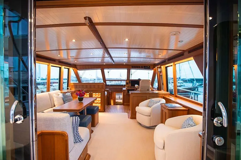 Slide: The Image of Luxurious salon with wood finishes, comfortable sofas, and panoramic windows on a yacht. - 22