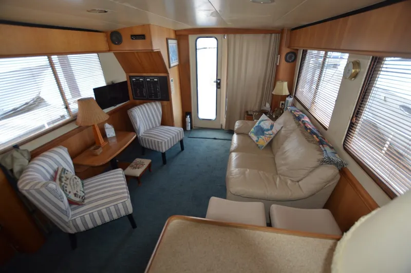 Slide: The Image of Interior of 2005 Mainship 34 Trawler with cozy seating and nautical decor. - 16