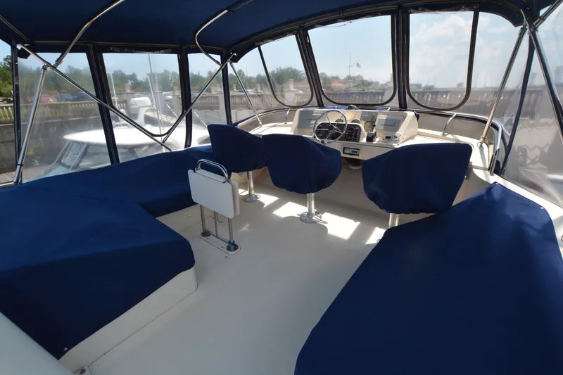 Slide: The Image of 2005 Mainship 34 Trawler cockpit with blue seating and helm station. - 7