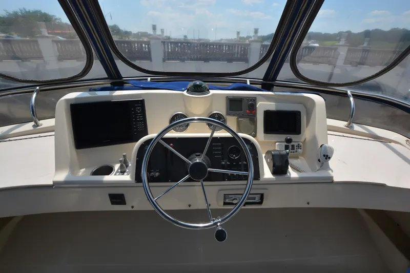 Slide: The Image of Helm of 2005 Mainship 34 Trawler with steering wheel and navigation equipment. - 6