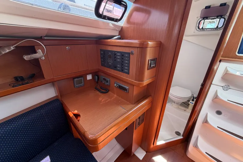 Slide: The Image of Interior of 2009 Beneteau Oceanis 31 sailboat with navigation station and compact bathroom. - 24