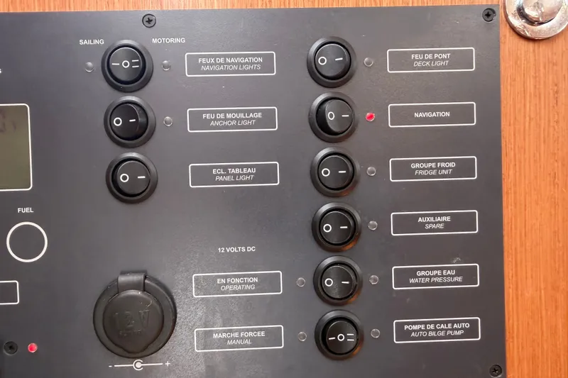 Slide: The Image of Control panel of a 2009 Beneteau Oceanis 31 sailboat with labeled switches. - 42