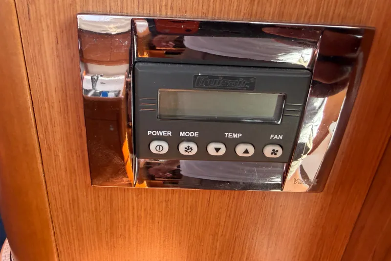 Slide: The Image of Control panel on 2009 Beneteau Oceanis 31 yacht, featuring power, mode, temperature, and fan settings. - 50