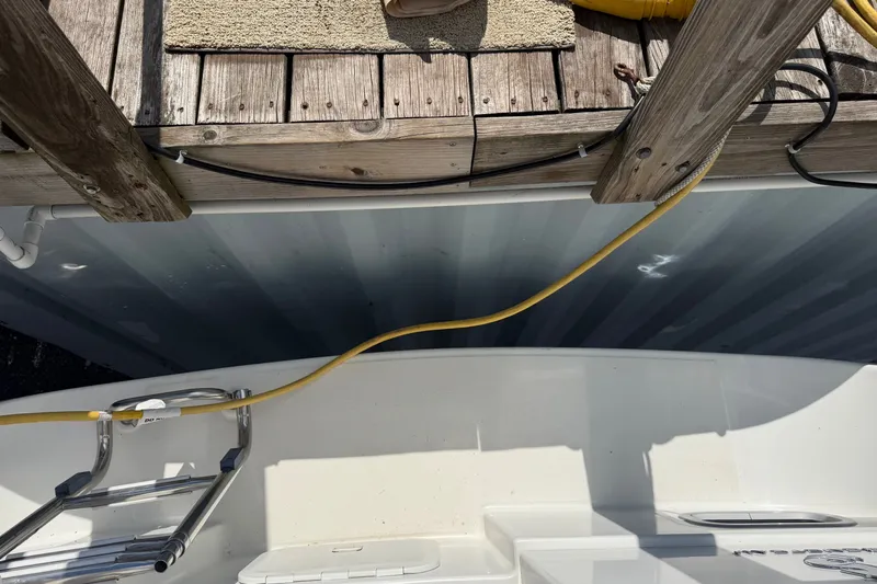 Slide: The Image of Beneteau Oceanis 31 (2009) docked, showing deck ladder and power cable connection. - 9