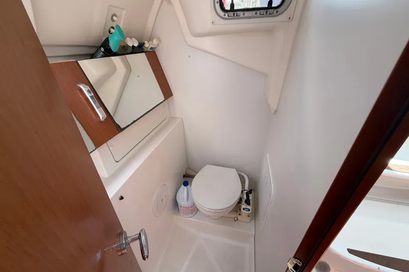 Slide: The Image of Compact bathroom in 2009 Beneteau Oceanis 31 sailboat with toilet and mirror cabinet. - 43