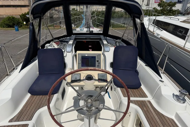 Slide: The Image of Cockpit of 2009 Beneteau Oceanis 31 sailboat with navigation equipment and seating. - 14
