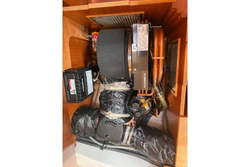 Slide: The Image of Engine compartment of a 2009 Beneteau Oceanis 31 sailboat, featuring Dometic components. - 28