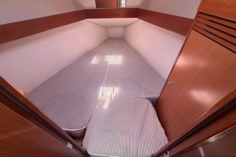 Slide: The Image of Cozy cabin interior of 2009 Beneteau Oceanis 31 sailboat with striped bedding. - 35